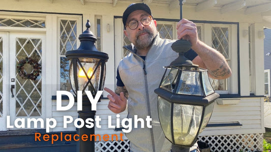 Bryan holding the damaged lamp beside the replacement lamp post light